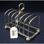 Silver six division toast rack with loop handle on ball feet. London hallmark, 6.96 troy ozs approx.