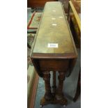 Late Victorian walnut drop-leaf table on turned supports and ceramic casters. (B.P. 24% incl.