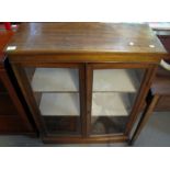 Early 20th Century mahogany two door glazed display cabinet or bookcase on a platform base. (B.P.