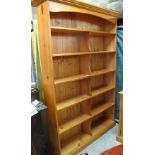 Large modern pine bookcase on a platform base with various compartments. (B.P. 24% incl.