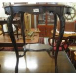 Edwardian mahogany occasional table of oval piecrust form with under tier, on outswept carved legs.