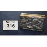 An oriental white metal matchbox holder, repousse decorated with dragons. (B.P. 24% incl.