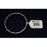 A large silver bangle with rope twist detail. (B.P. 24% incl.