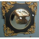 Circular bevel plate wall mirror with gilt mounted foliate frame. 25cm diameter approx. (B.P.