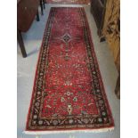 Middle Eastern red ground foliate runner. 81 x 290cm approx. (B.P. 24% incl.