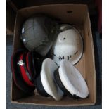 Box of military helmets and hats to include; two sailors caps (one H.M.S Nelson, other H.M.