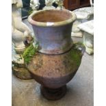 Classical design terracotta weathered garden pot or planter of baluster form with two lug handles.