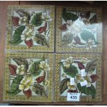 Set of four Art Nouveau transfer printed floral and foliate tiles with geometric borders. (B.P.
