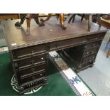 Early 20th Century oak pedestal knee hole desk having leather inset top with a bank of three