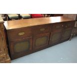 Modern mahogany sideboard, having brass recessed handles and leather panels. (B.P. 24% incl.