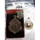 Two silver and one gold plated, brass fob. (B.P. 24% incl.