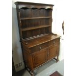 Early 20th Century oak two stage rack back dresser with mask lion loop handles. (B.P. 24% incl.