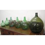 Collection of six green glass carboys, varying sizes. (6) (B.P. 24% incl.