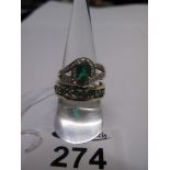 A 9ct gold diamond and emerald ring and a 9ct gold diamond and emerald eternity style ring, 7.