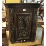 Small carved oak blind panelled hanging corner cupboard overall with carved squirrel and acorn