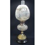 Early 20th Century double burner oil lamp with cut glass reservoir on yellow metal pedestal base