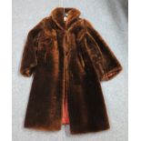A brown knee length vintage mouton fur coat by Tescan. (B.P. 24% incl.