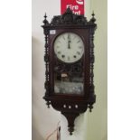 19th Century stained walnut carved two train wall clock. (B.P. 24% incl.