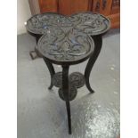 Heavily carved and stained clover shaped occasional table with smaller clover under tier on