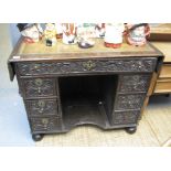 18th Century style carved oak drop leaf writing desk with leather inset top,