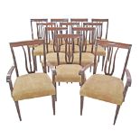 A set of twelve mahogany dining chairs upholstered in beige alcantara, two armchairs and ten chairs,