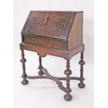 A William and Mary style oak bureau, the top with cushion moulded border under the slope,