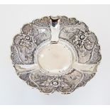 A Sterling silver bowl repousse with roses and flowers, on three small feet. W170mm, weight 147g.