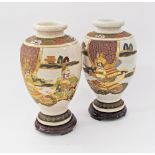 A pair of Satsuma style vases on carved wood bases. The vases H32cm. (4)