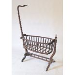 An old wooden rocking baby crib on stand, turned baluster railing circa early 20th century.