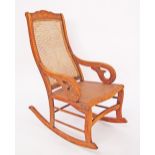 An oak and caned rocking chair W53cm, H104cm