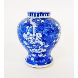 A Chinese ovoid vase, painted in tones of underglaze blue with blossoming prunus, double circle