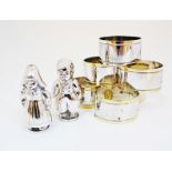A pair of silver plated salt & pepper cellars in the form of Dutch children H70mm, together with a