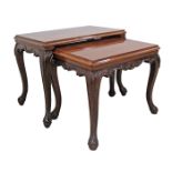 A carved walnut vintage nest of two coffee tables 1950-60s on cabriole legs H46cm 60X37cm and H42cm,