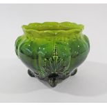 An Art Nouveau pottery jardiniere in green glaze with carved leaf decoration marked R211523 (date