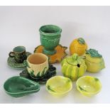 A collection of French ceramic containers in yellow and green glazing, the tallest H14cm. (16)