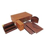 A collection of desk accessories comprising a wooden box with lock and key, two letter holders, a