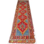 A hand knotted Persian Turkish Oushak runner wool carpet in red and turquoise colours in geometric