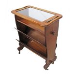 A four tier beechwood magazine rack / tea table on castors, the top tray removable with cross