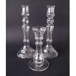 Three clear glass candlesticks, H30cm, H19cm. (3)