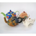 A collection of four ceramic tea pots. (8)