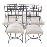 A set of eight wrought and strap iron garden chairs painted black with beige cushions. H98cm,