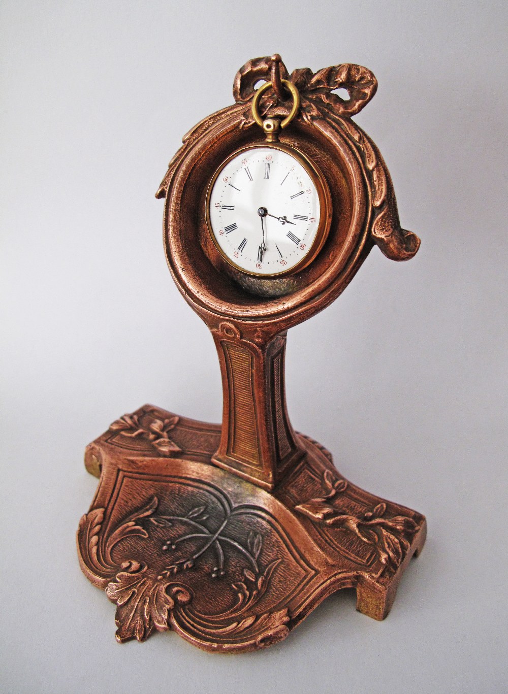 French gold pocket watch on stand