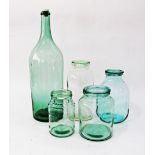 A collection of vintage green glass jars with covers and an oil bottle, the tallest H52cm. (5)