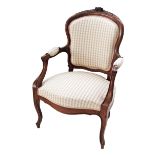 A French carved walnut Louis XV style open armchair in beige chequered upholstery. H94cm, W62cm.