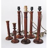 A collection of six wooden candlesticks, four of which are converted to table lamps - H37cm, the