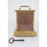 An Antique carriage clock in brass casing and glass with winding key, c19th century. H18cm, W13cm.