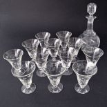 A vintage c 1950s set of twelve engraved port footed glasses H8.5cm together with a bottle and