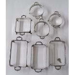 A collection of silver plated galleried serving dish warmer receptors with handles, three round
