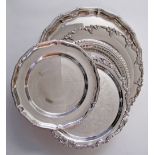 A collection of five silver plated round dinner serving dishes, with gadrooned rims, ranging from
