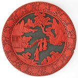 A Large Chinese red on black cinnabar carved lacquer on wood base charger mid 20th century. W32,5cm.